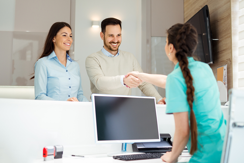 Couple speaking to front desk