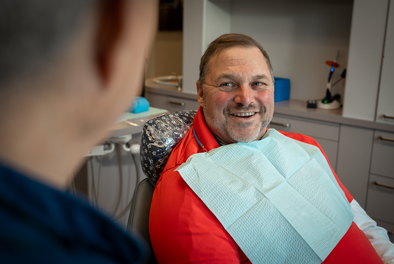 Bobby with bib in chair