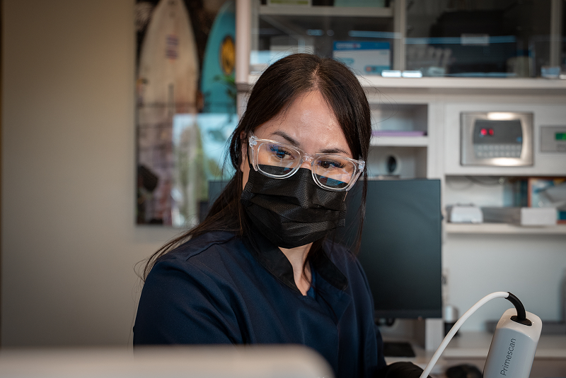 Team member using instrument to get digital map of mouth