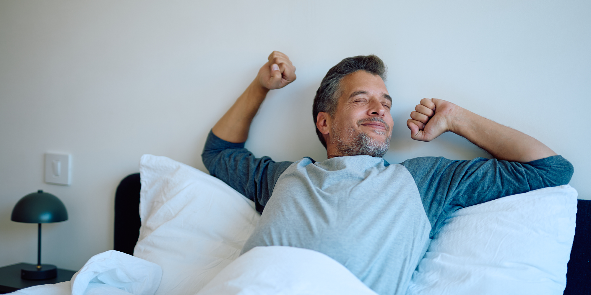 man waking up from a good nights rest