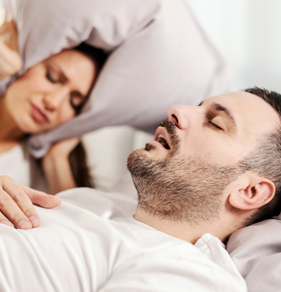 a male sleeping on his back snoring