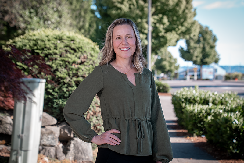 Dr. Vernon standing outside with hands on her hip in casual attire