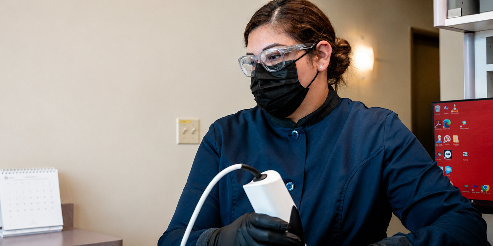staff member using the intraoral scanner on a patient