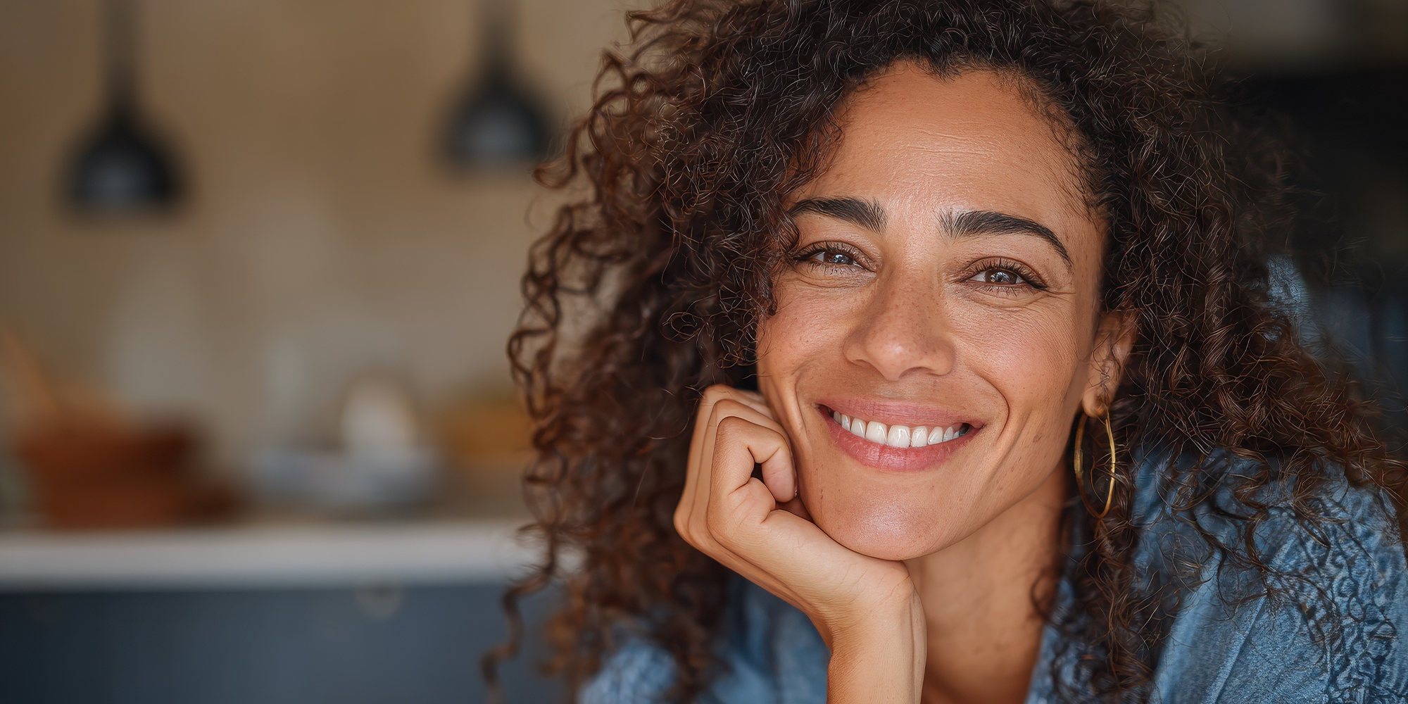 woman smiling with her hand on her chin